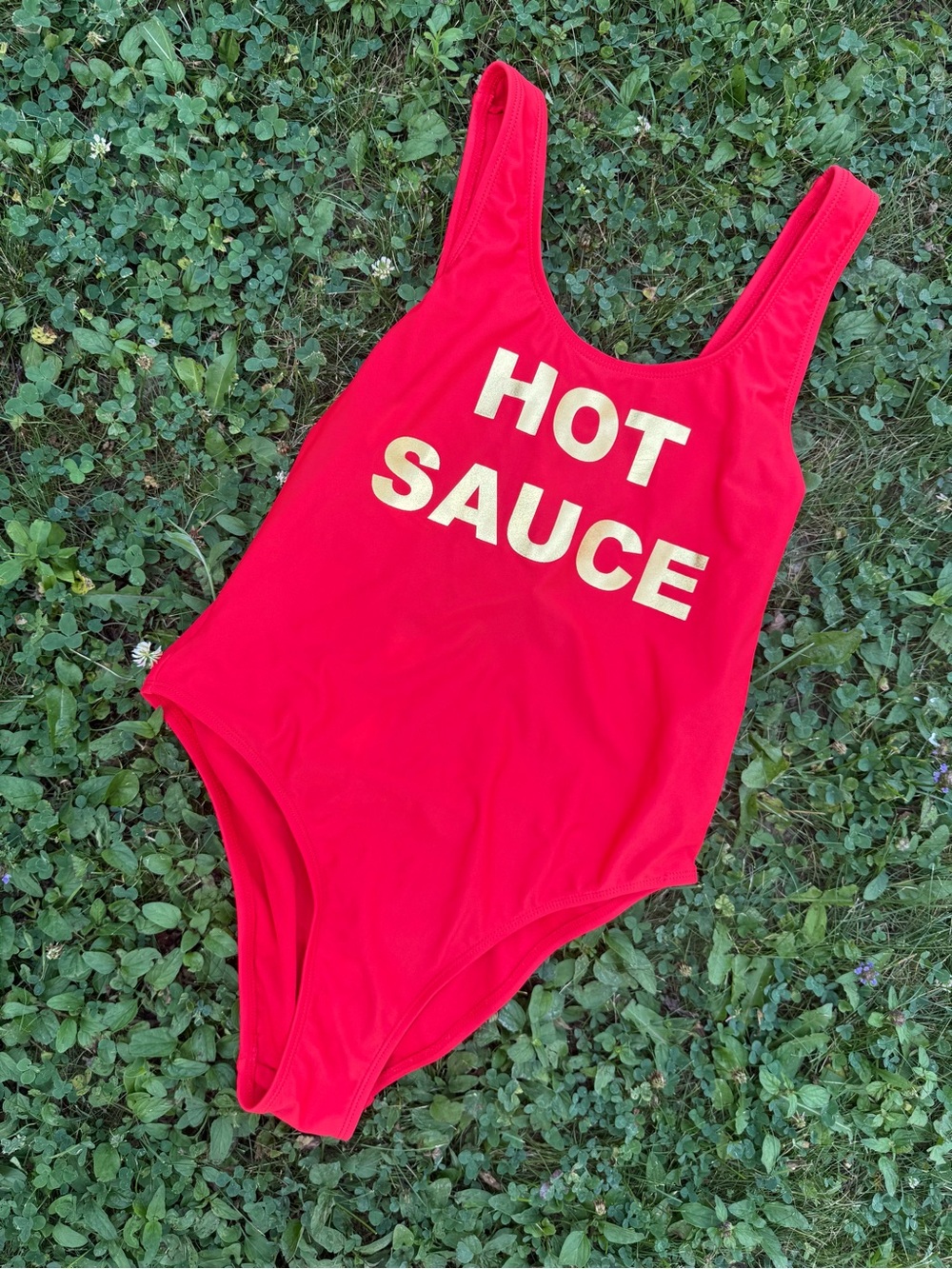 One piece bathing suit with “Hot Sauce” graphic. Low cut back (small)